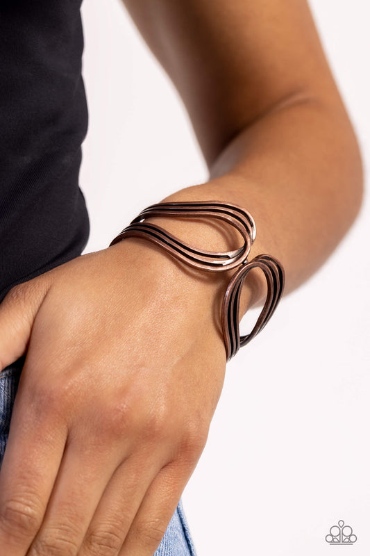 Shockwave Attitude - Copper Cuff Bracelet  - Paparazzi Accessories - Featuring a rustic finish, flat copper bars delicately loop and overlap into two airy copper frames around the wrist that delicately connect into a layered bangle-like bracelet. Features a hinged closure. Sold as one individual bracelet.