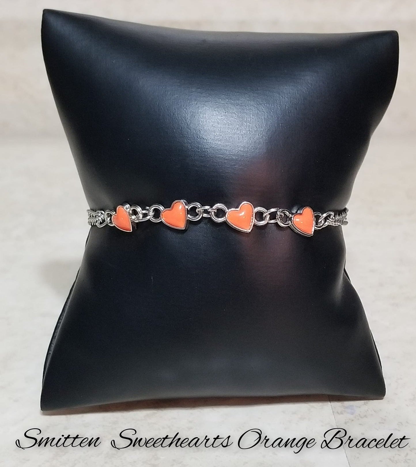 Smitten Sweethearts - Orange Bracelet - Paparazzi Accessories - Nestled in dainty silver frames, a quad of vibrant orange heart-shaped pendants delicately links across the wrist on a double strand of silver chains for a dash of swoon-worthy color.