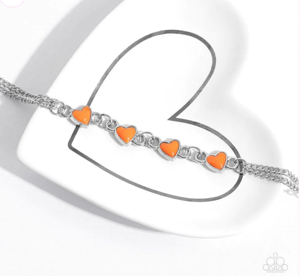 Smitten Sweethearts - Orange Bracelet - Paparazzi Accessories - Nestled in dainty silver frames, a quad of vibrant orange heart-shaped pendants delicately links across the wrist on a double strand of silver chains for a dash of swoon-worthy color.