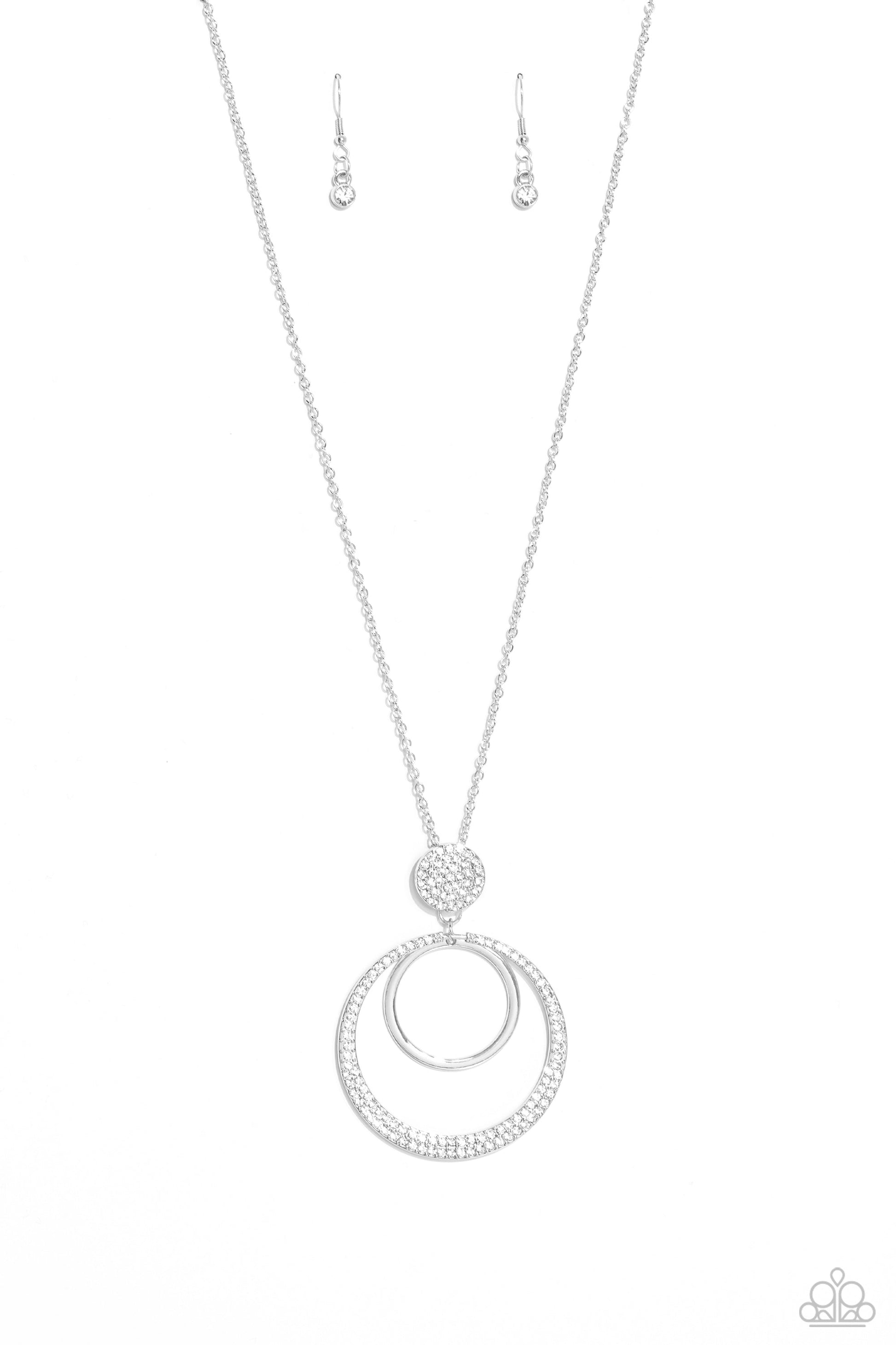 Spanish Sizzle - White and Silver Necklace - Paparazzi Accessories - Two rings, one a high-sheen silver, the other, an oversized warped ring embossed with dainty white rhinestones, swing from the bottom of a glistening silver pendant embossed with rhinestones in the same hue, creating a sparkly, stacked pendant. The glittery display falls from an elongated, classic silver chain, lengthening the torso.