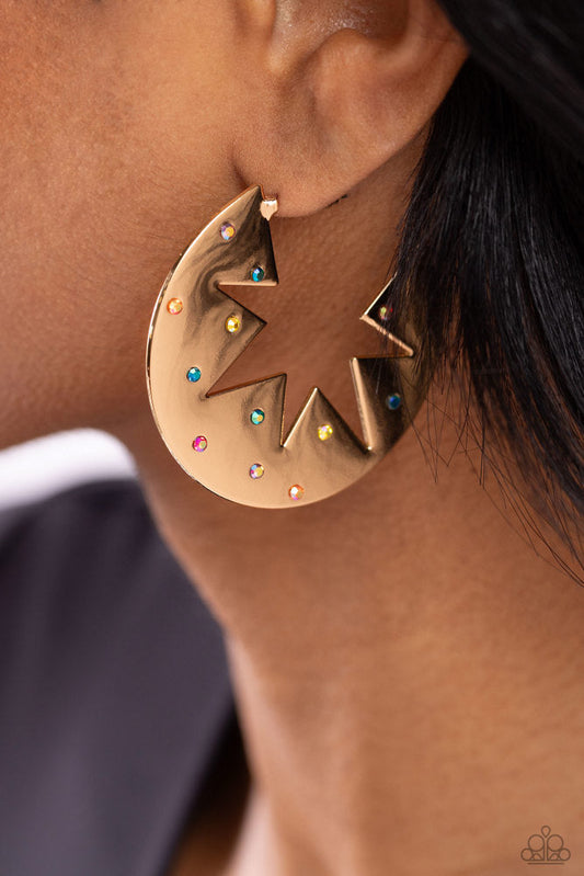 Starry Sensation - Gold Hoop Earrings - Paparazzi Accessories - Sporadically dotted with various multicolored and iridescent rhinestones, a three-dimensional star outline explodes from the center of a polished gold disc for an out-of-this-world centerpiece. Earring attaches to a standard post fitting. Hoop measures approximately 1 3/4" in diameter.