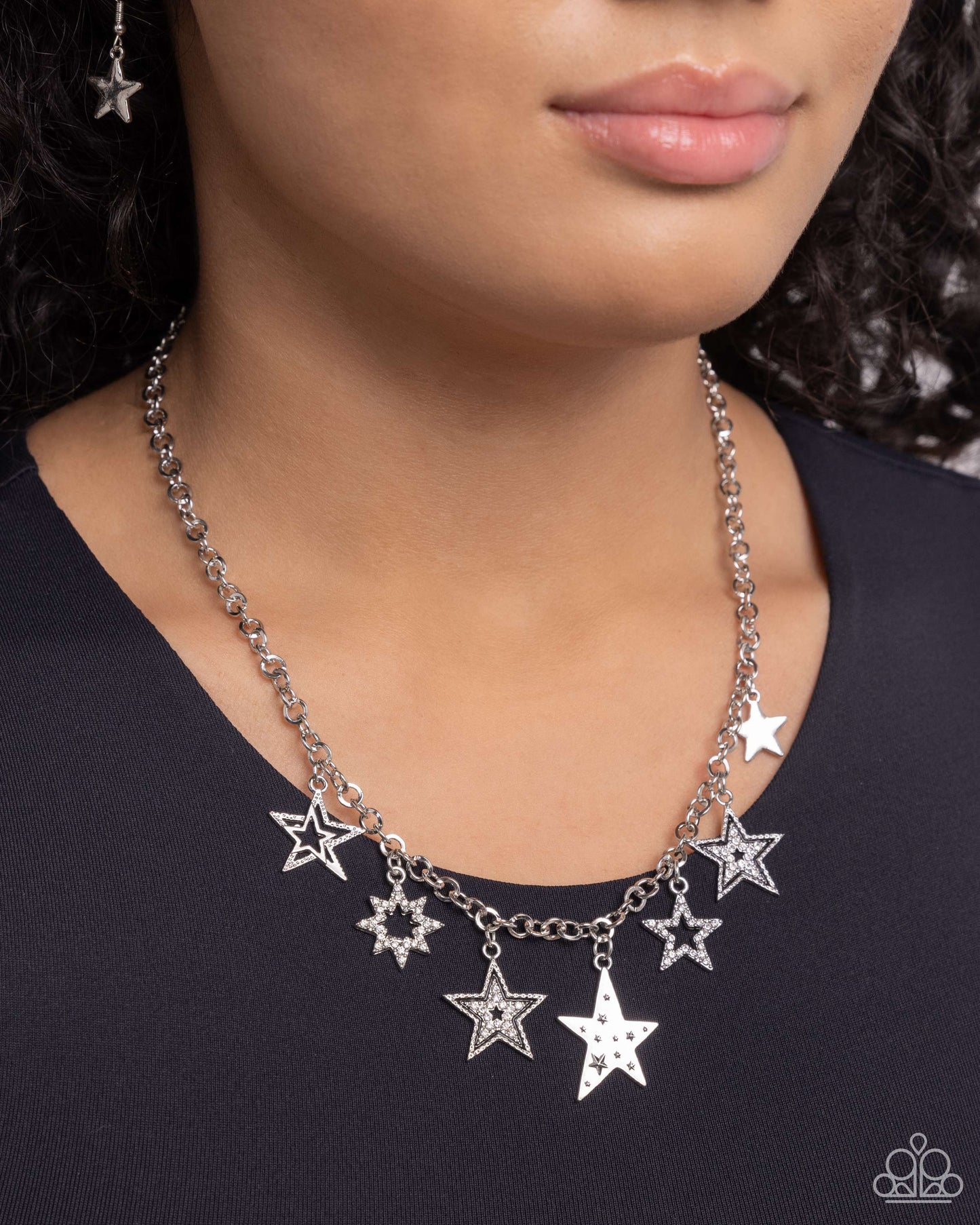 Starstruck Sentiment - Black and Silver Necklace - Paparazzi Accessories - Cascading from a classic silver chain, a collection of eclectic silver stars, some featuring white rhinestones, black-painted detailing, star-like texture, and layers, cascade around the neckline for a stellar statement.