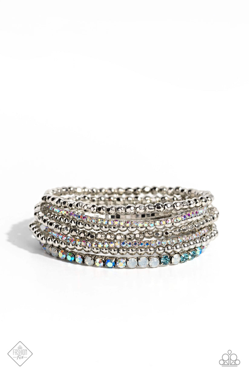 Stellar Sequence - Blue and Silver Bracelets - Paparazzi Accessories - A mismatched collection of smooth and faceted silver beads collides with strands of aquamarine, opalescent, blue iridescent, and iridescent rhinestones set in square fittings to create an irresistibly stellar stack of stretchy bracelets. Sold as one set of seven bracelets.