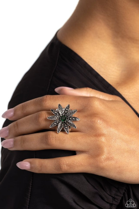 Sunflower Season - Green Flower Ring - Paparazzi Accessories - Unfurling around an emerald gem center, textured and studded silver petals alternate atop airy silver bands on the finger for a whimsically botanical centerpiece. Features a stretchy band for a flexible fit.