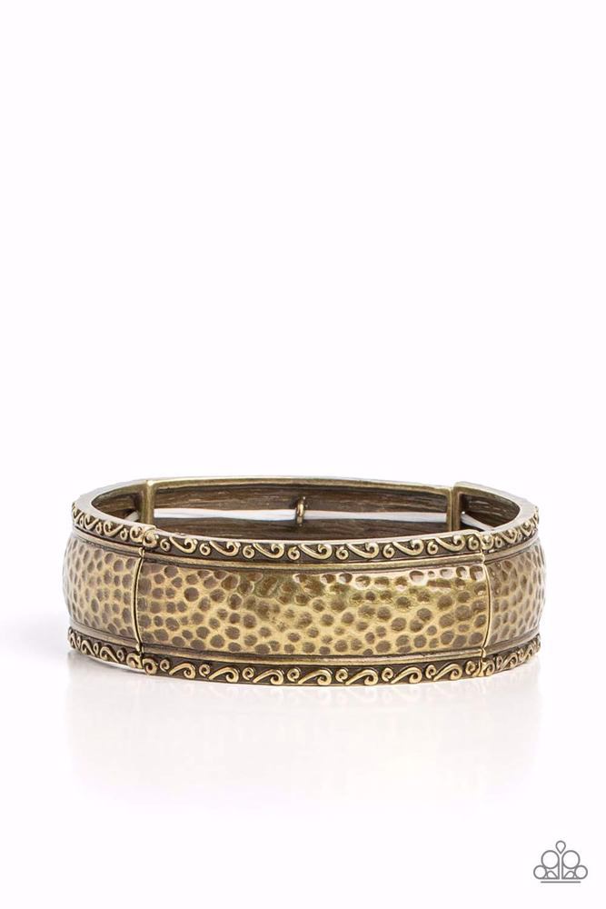 Textile Tenor - Brass Bracelet - Paparazzi Accessories - Curved frames of antiqued brass curve around the wrist on elastic stretchy bands. Studs and ribbons of brass curl into a dainty filigree above and below its hammered center for a soft and dauntless combo.