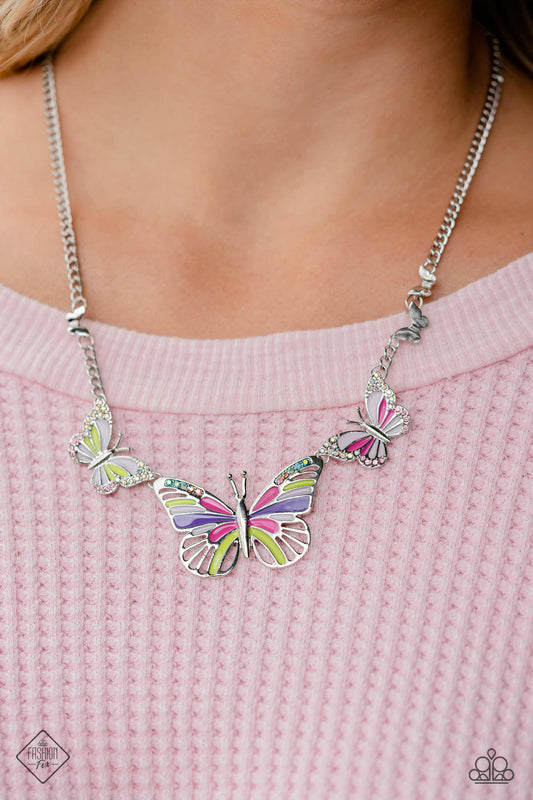 The FLIGHT Direction - Multi Butterfly Necklace - Paparazzi Accessories - Featuring Fuchsia Fedora, Love Bird, purple, and baby pink details, a trio of butterflies links along the neckline for a whimsical pop of color. Each elaborate butterfly is sprinkled with dainty multicolored and iridescent rhinestones, adding a dazzling touch of sparkle. Finishing off the design, additional dainty silver butterflies climb along each side of the classic silver chain for a fanciful finish.
