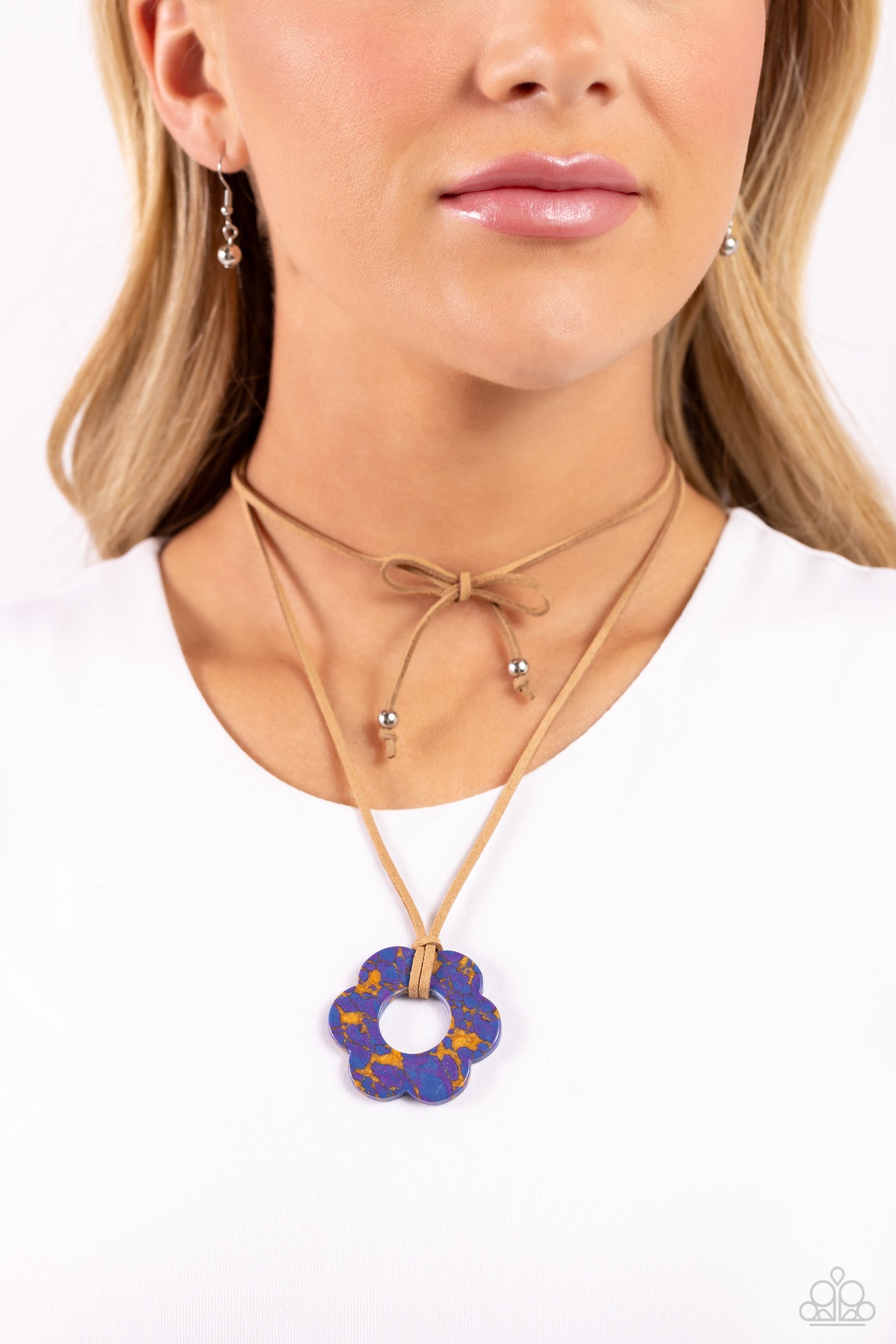 Tied Triumph - Purple Flower Necklace - Paparazzi Accessories - Featuring purple and brown marbling, an airy blue flower is knotted at the bottom of a lengthened strand of brown suede for a southwestern-inspired statement. Features an adjustable tie closure.