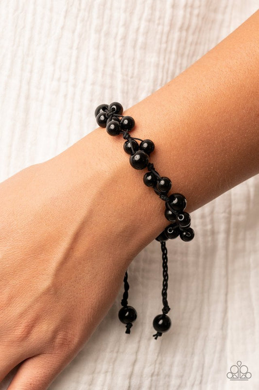 Vintage Versatility - Black Bracelet - Paparazzi Accessories - Bubbly clusters of black beads are decoratively knotted around the wrist, adding a timeless twist to the classic centerpiece.