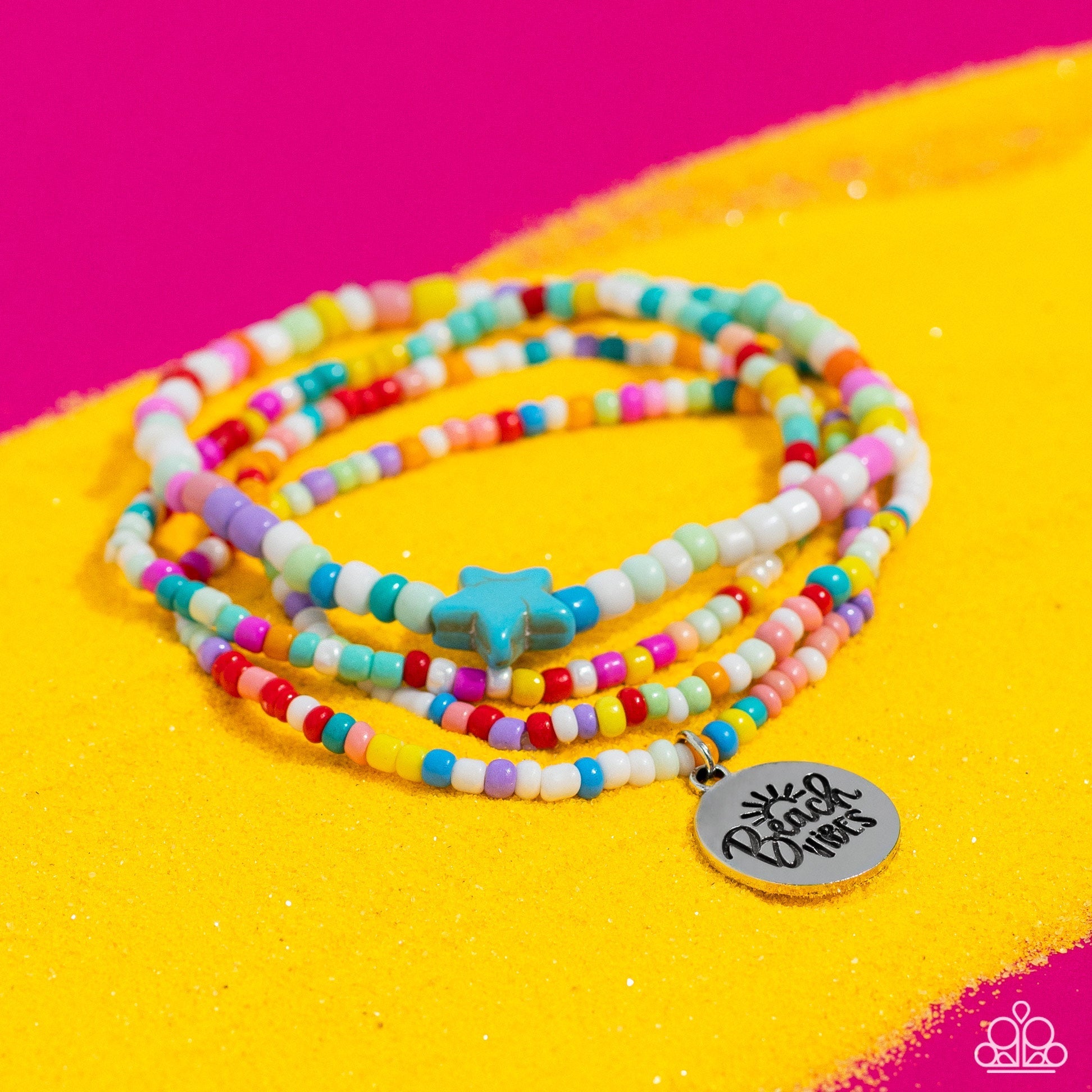 Wave Riding - Multi Color Bracelet - Paparazzi Accessories - Multicolored seed beads wrap around the wrist on elastic stretchy bands for a vivacious pop of color. A turquoise stone star is infused on one of the strands, adding an earthy flourish to the design, while a silver disc stamped with a sun embellishment and the phrase "Beach Vibes".