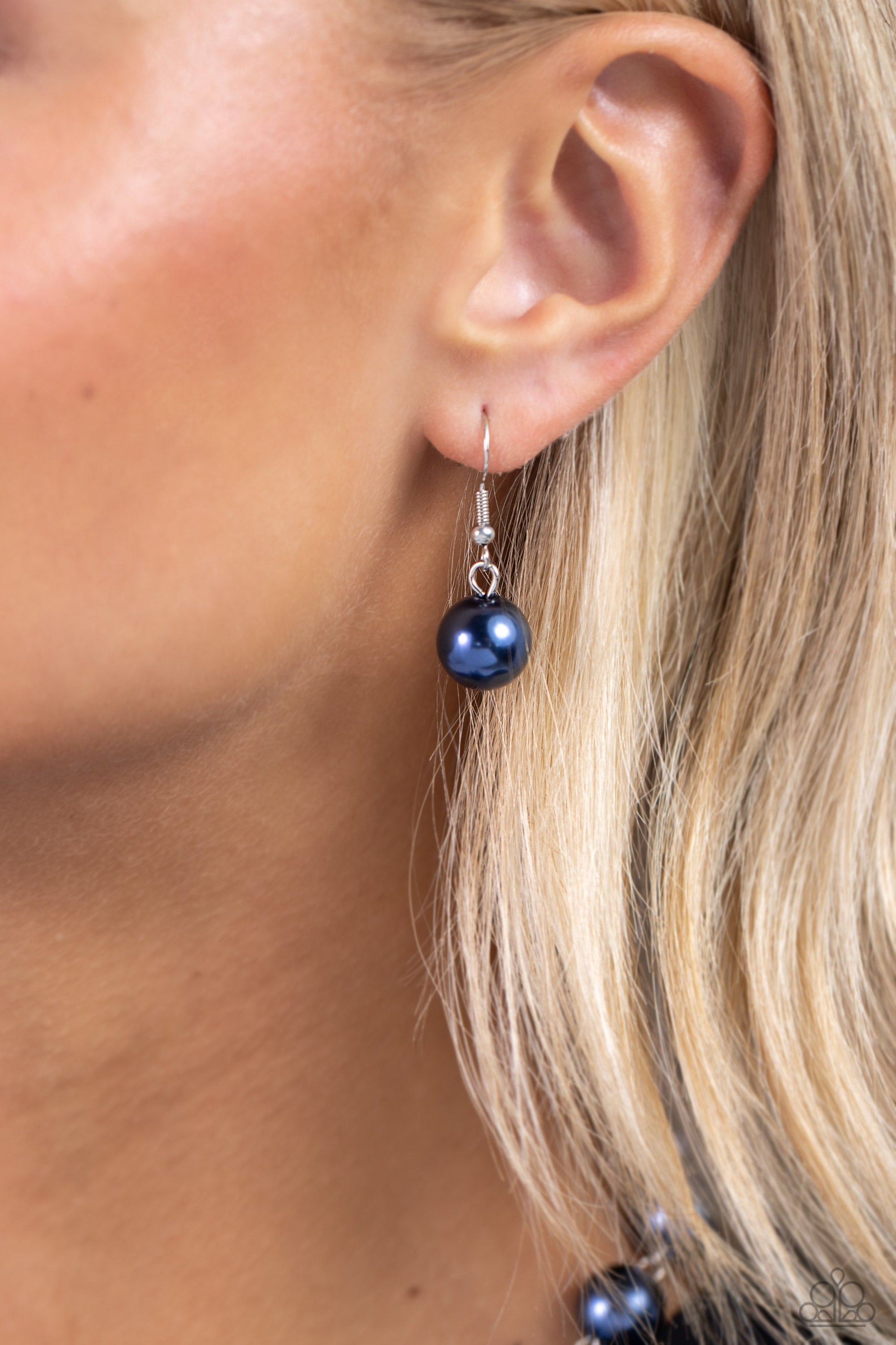White Collar Welcome - Blue Pearl Necklace - Paparazzi Accessories - Montana pearls trickle below the collar attaching to a silver hoop as it nears the center of the chest. Accented with oversized Montana pearls, rhinestone-encrusted beads, faceted clear beads, and strands of silver chains cascade from the bottom of the silver hoop creating a charming, refined display.