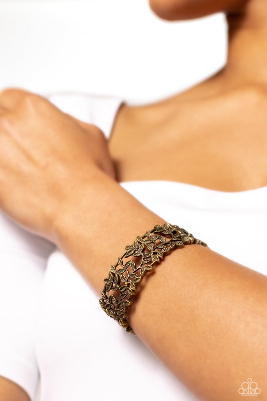 Whose VINE Is It Anyway? - Brass Bracelet - Paparazzi Accessories - Dotted with intricate textures, brass filigree vines with tactile leaves, as they twist and wind across the wrist on elastic stretchy bands for a whimsical look. Sold as one individual bracelet.