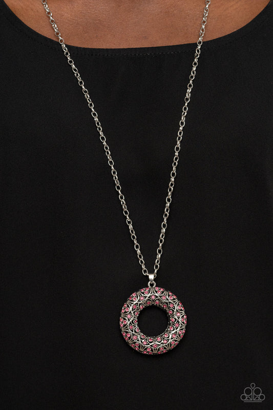 Wintry Wreath - Pink and Silver Necklace - Paparazzi Accessories - Dotted with glittering pink rhinestones and filled with frilly silver filigree accents, an oversized silver wreath sparkles from the bottom of an extended silver chain for a whimsical fashion.