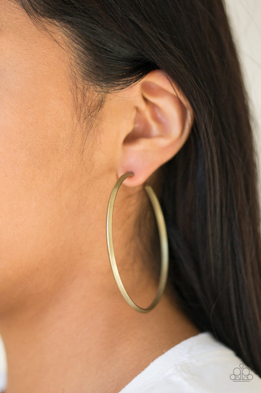 5th Avenue Attitude - Brass Hoop Earrings - Paparazzi Accessories - Brushed in an antiqued shimmer, a glistening brass bar curls into a sleek hoop for a classic look. Earring attaches to a standard post fitting. Hoop measures 2 1/2" in diameter. Sold as one pair of hoop earrings.