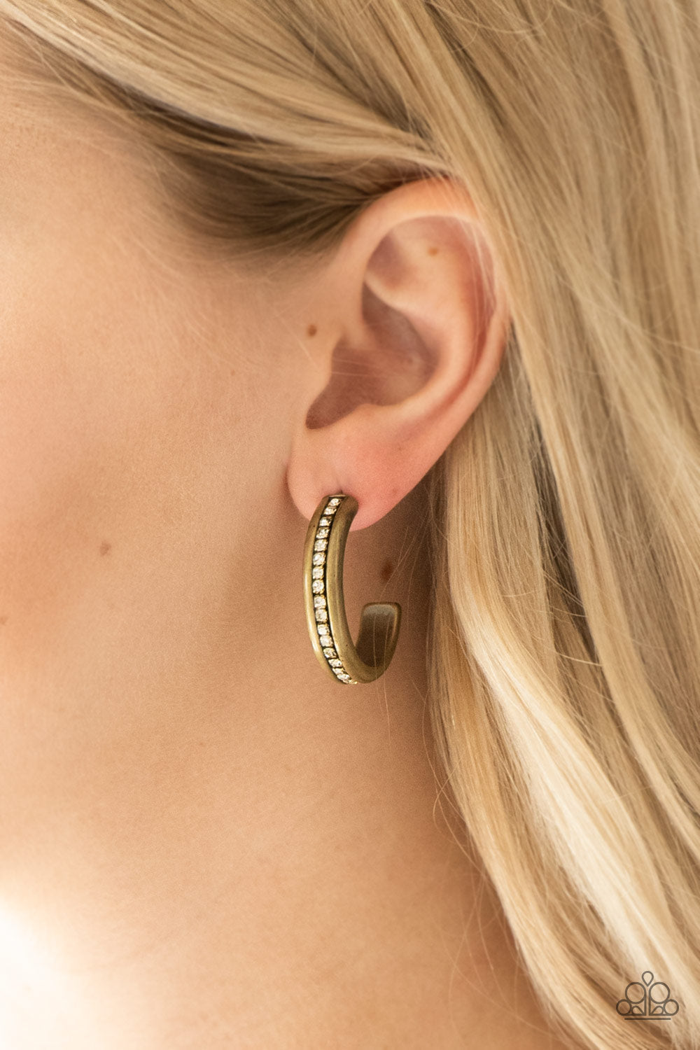 5th Avenue Fashionista - Brass Hoop Earrings - Paparazzi Accessories - A row of glassy white rhinestones is encrusted down the spine of a burnished brass hoop for a refined look. Earring attaches to a standard post fitting. Hoop measures 1 1/4" in diameter. Sold as one pair of hoop earrings.