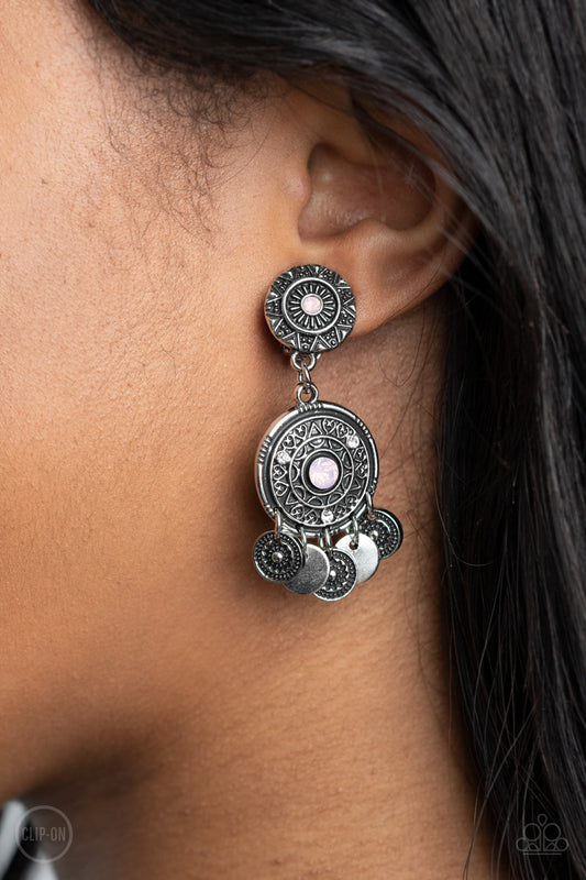 A DREAMCATCHER Come True - Pink Floral - Silver Clip On Earrings - Paparazzi Accessories - 
Dainty silver discs and antiqued floral frames dance from the bottom of an ornately embossed silver frame that links to a matching silver fitting. Both frames are dotted in pink opalescent rhinestone centers, while the largest of frames is sprinkled in dainty white rhinestone accents for a dreamy finish. Earring attaches to a standard clip-on fitting.
