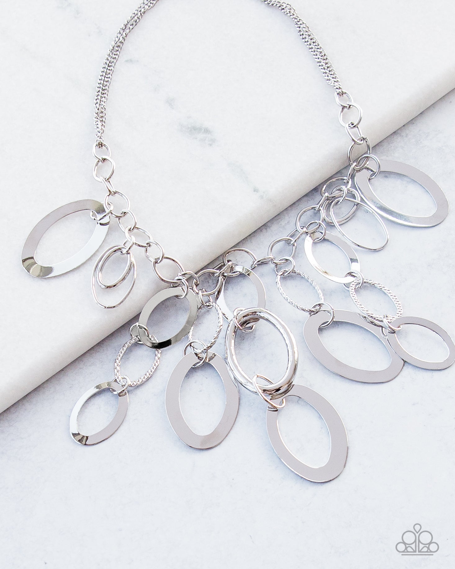 A Silver Spell - Silver Necklace - Paparazzi Jewelry - Bejeweled Accessories By Kristie - Large silver links and shimmering textured silver rings cascade below a silver chain freely, allowing for movement that makes a bold statement.