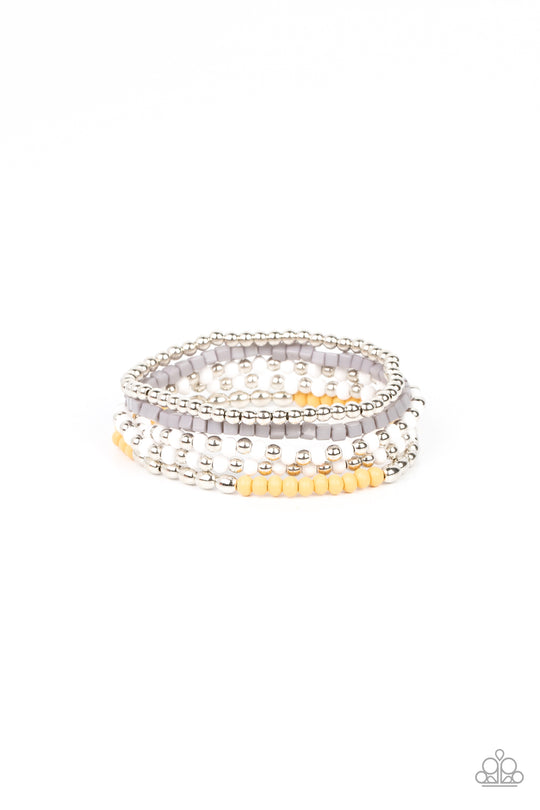 Adventure Is Calling - Silver and Yellow Fashion Bracelet - Paparazzi Accessories - Featuring the neutral shades of white, Northern Droplet, silver, and Daffodil, an adventurous assortment of round and cube beads are threaded along stretchy bands around the wrist for a colorfully layered look. Sold as one set of four bracelets.