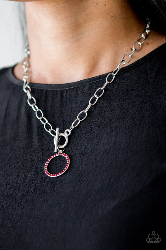 All In Favor - Red and Silver Necklace - Paparazzi Accessories - Encrusted in fiery red rhinestones, a bubbly silver pendant swings below the collar for a colorfully casual look. Features a toggle closure.
