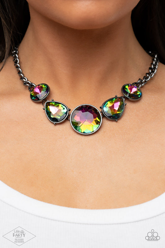 All The Worlds My Stage - Oil Spill Multi Color - Gunmetal Necklace - Paparazzi Accessories - Heavy gunmetal chain and an exaggerated display of round and teardrop-shaped oil spill rhinestones connects below the collar for a blinding look. Features an adjustable clasp closure.