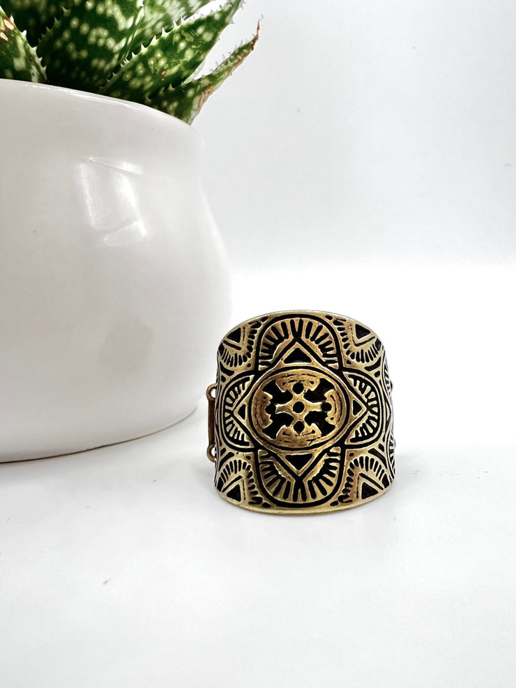 Argentine Arches - Brass Ring - Paparazzi Accessories - Engraved geometric shapes, lines, and patterns fill a brass plate that curves around the finger, creating a trendy centerpiece fashion ring.