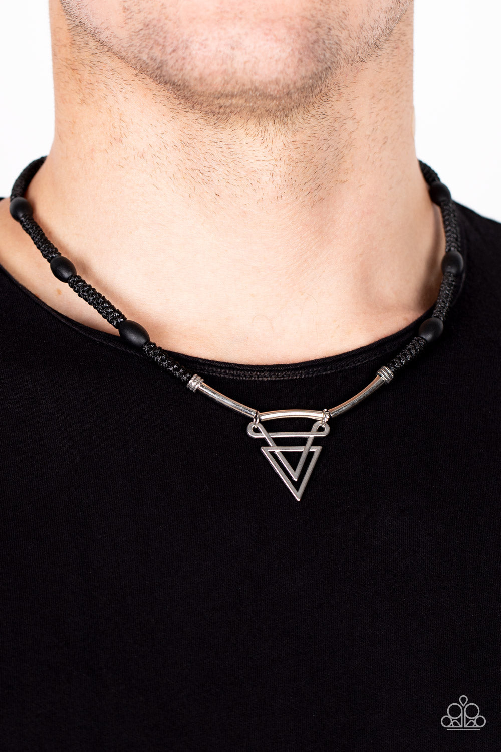 Arrowed Admiral - Black Urban Necklace - Paparazzi Accessories - Black wooden beads are knotted in place along a braided black cord below the collar. Infused with silver rod-like beads, an ornately stacked silver triangular pendant swings from the center for a sharp finish.