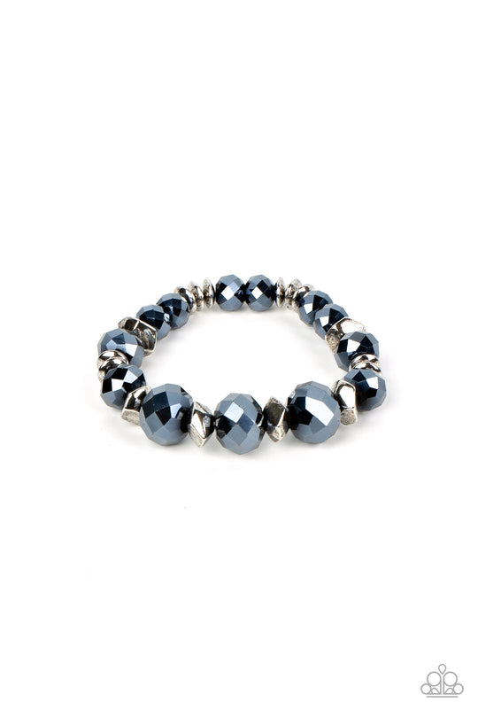 Astral Auras - Blue and Silver Bracelet - Paparazzi Accessories - Separated by silver discs and faceted silver accents, faceted blue crystal-like gems are threaded along stretchy bands around the wrist for a stellar statement fashion bracelet.