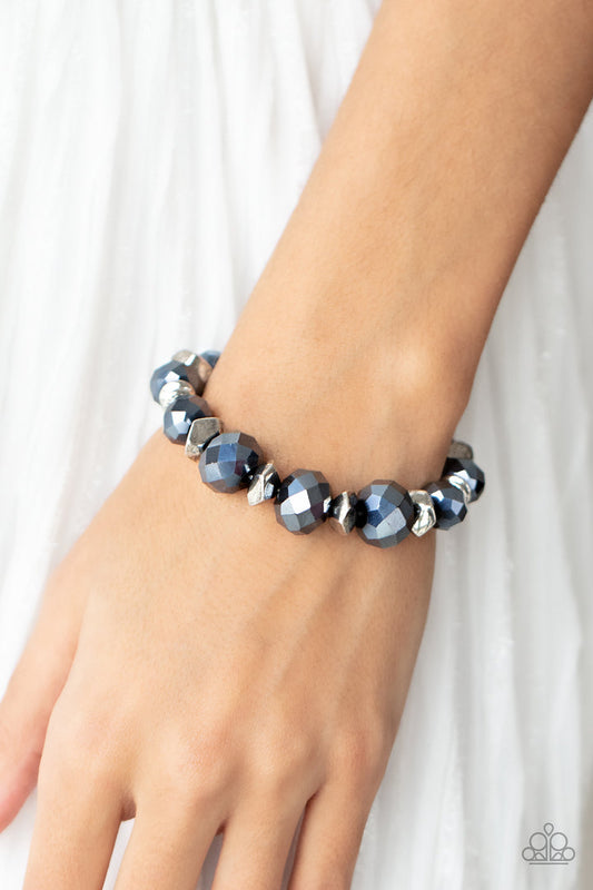 Astral Auras - Blue and Silver Bracelet - Paparazzi Accessories - Separated by silver discs and faceted silver accents, faceted blue crystal-like gems are threaded along stretchy bands around the wrist for a stellar statement bracelet.