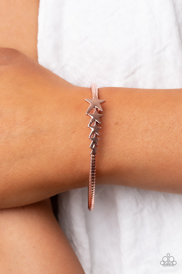 Astrological A-Lister - Copper Bracelet - Paparazzi Accessories - Shiny copper stars graduate in size across the center of a hammered shiny copper bangle, creating a stackable stellar centerpiece around the wrist. Sold as one individual bracelet. Trendy fashion jewelry for everyone.