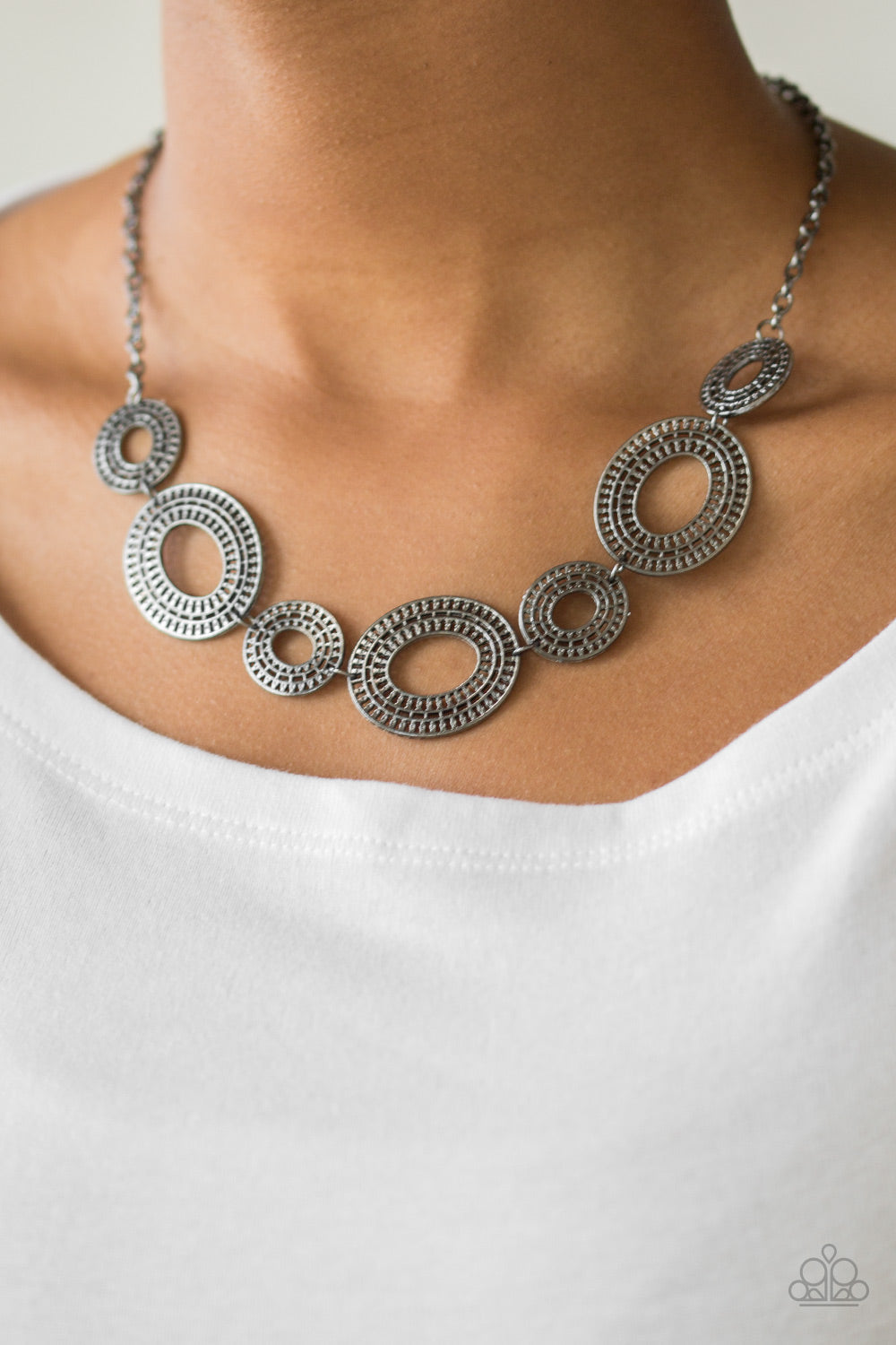 Basically Baltic - Black Gunmetal Necklace - Paparazzi Accessories - Radiating with circular details, airy oval frames link below the collar for a casual stylish necklace.