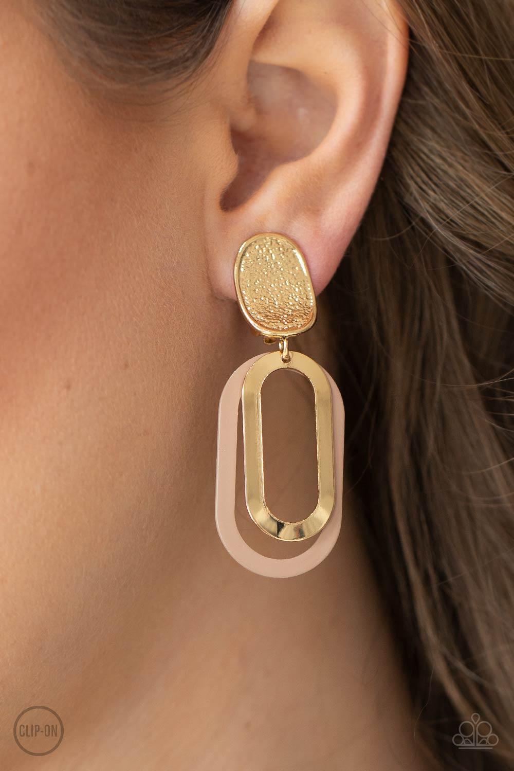 ​Melrose Mystery - Brown and Gold - Clip On Earrings - Paparazzi Accessories - Shiny gold and Iced Coffee oblong hoops dangle one in front of the other from a shimmery textured gold oval disc for an upscale finale. Earring attaches to a standard clip-on fitting. Sold as one pair of clip-on earrings.