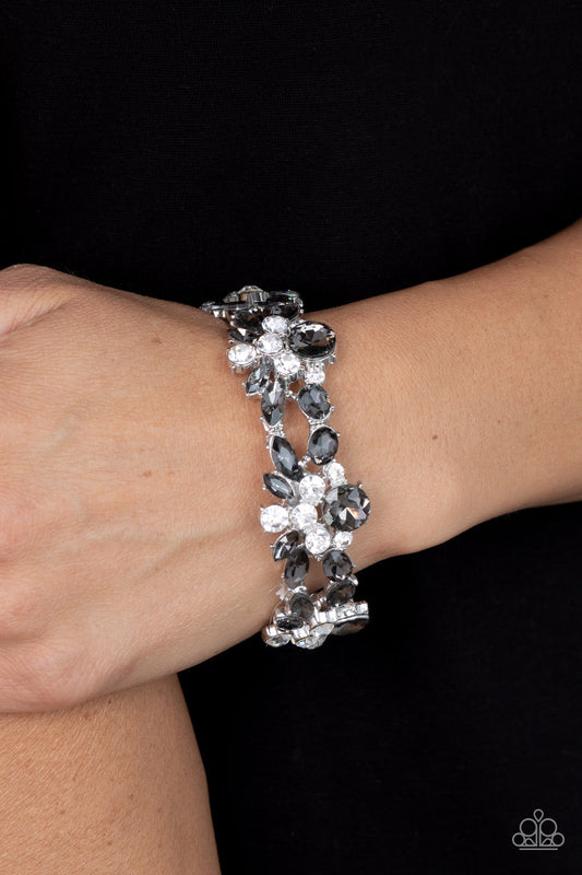 Beloved Bling - Silver Rhinestone Bracelet - Paparazzi Accessories - Crowned with a smoky rhinestone, stacks of classic white and smoky marquise cut rhinestones coalesce into scintillating clusters. The glassy clusters are threaded along stretchy bands creating a dazzling display around the wrist. Sold as one individual bracelet.