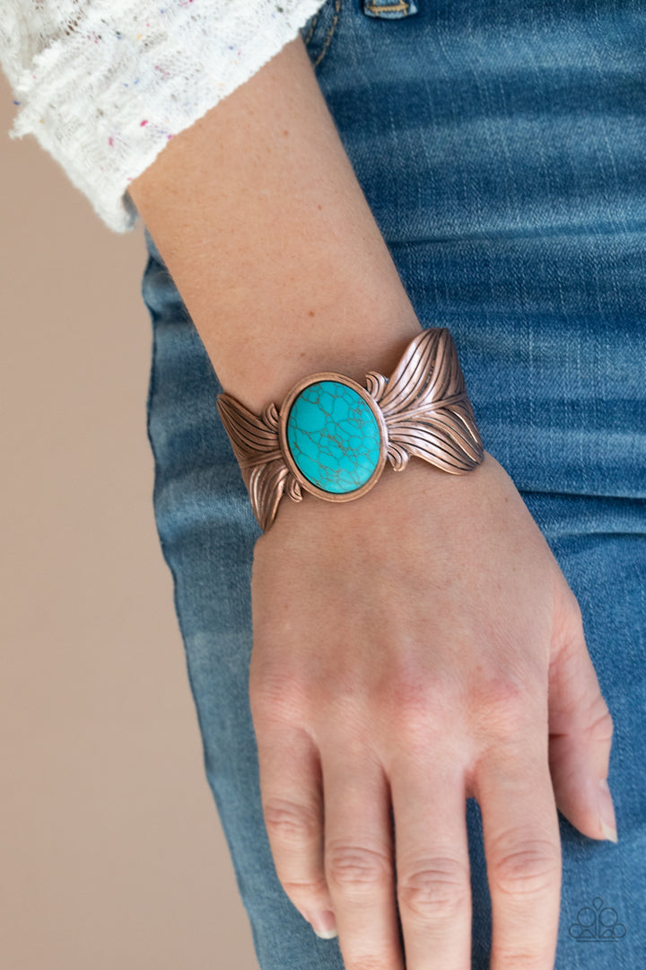 Born To Soar - Blue and Copper Cuff Bracelet - Paparazzi Jewelry - Bejeweled Accessories By Kristie - Etched and embossed in lifelike textures, two oversized copper feathers branch out from a refreshing turquoise stone center, curling into a whimsical cuff around the wrist. Sold as one individual bracelet.