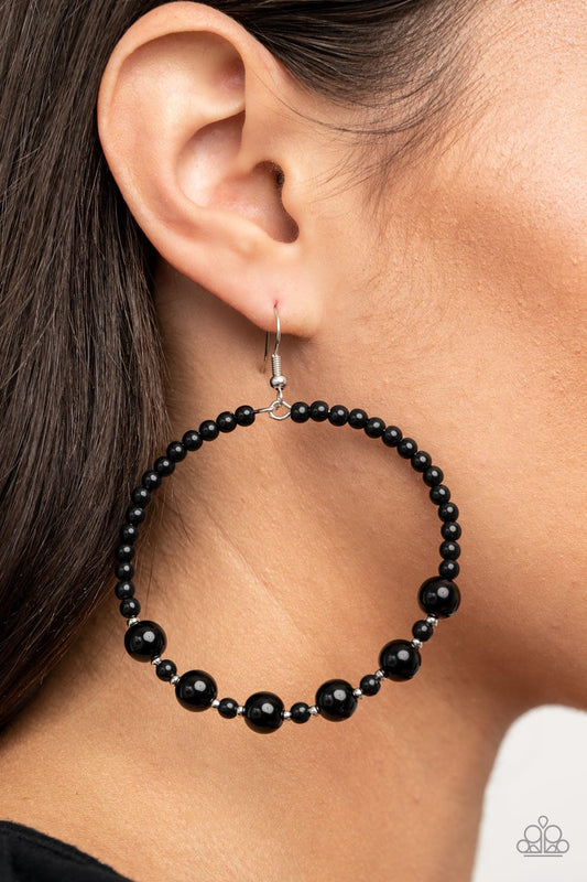 Boss Posh - Black and Silver Fashion Earrings - Paparazzi Accessories - Varying in shape and size, a bubbly array of polished black beads and dainty silver accents glide along a wire hoop for a classy finish. Earring attaches to a standard fishhook fitting. Sold as one pair of earrings.