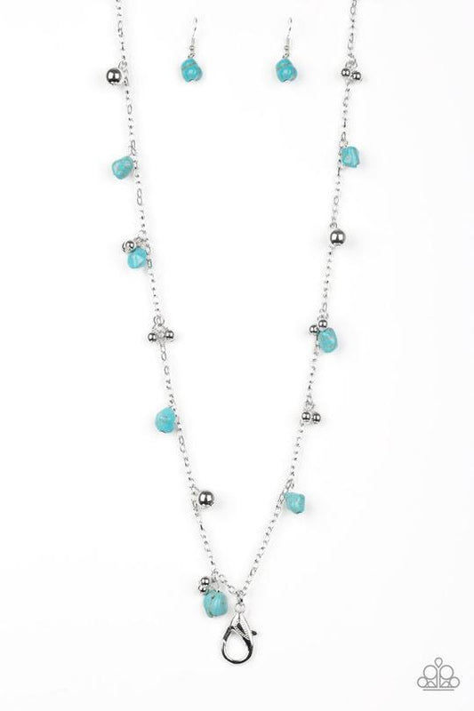 Both Feet On The Ground - Blue Turquoise and Silver Lanyard - Paparazzi Accessories - Refreshing turquoise pebbles and an array of glistening silver beads trickle along a lengthened silver chain for a seasonal look. A lobster clasp hangs from the bottom of the design to allow a name badge or other item to be attached.