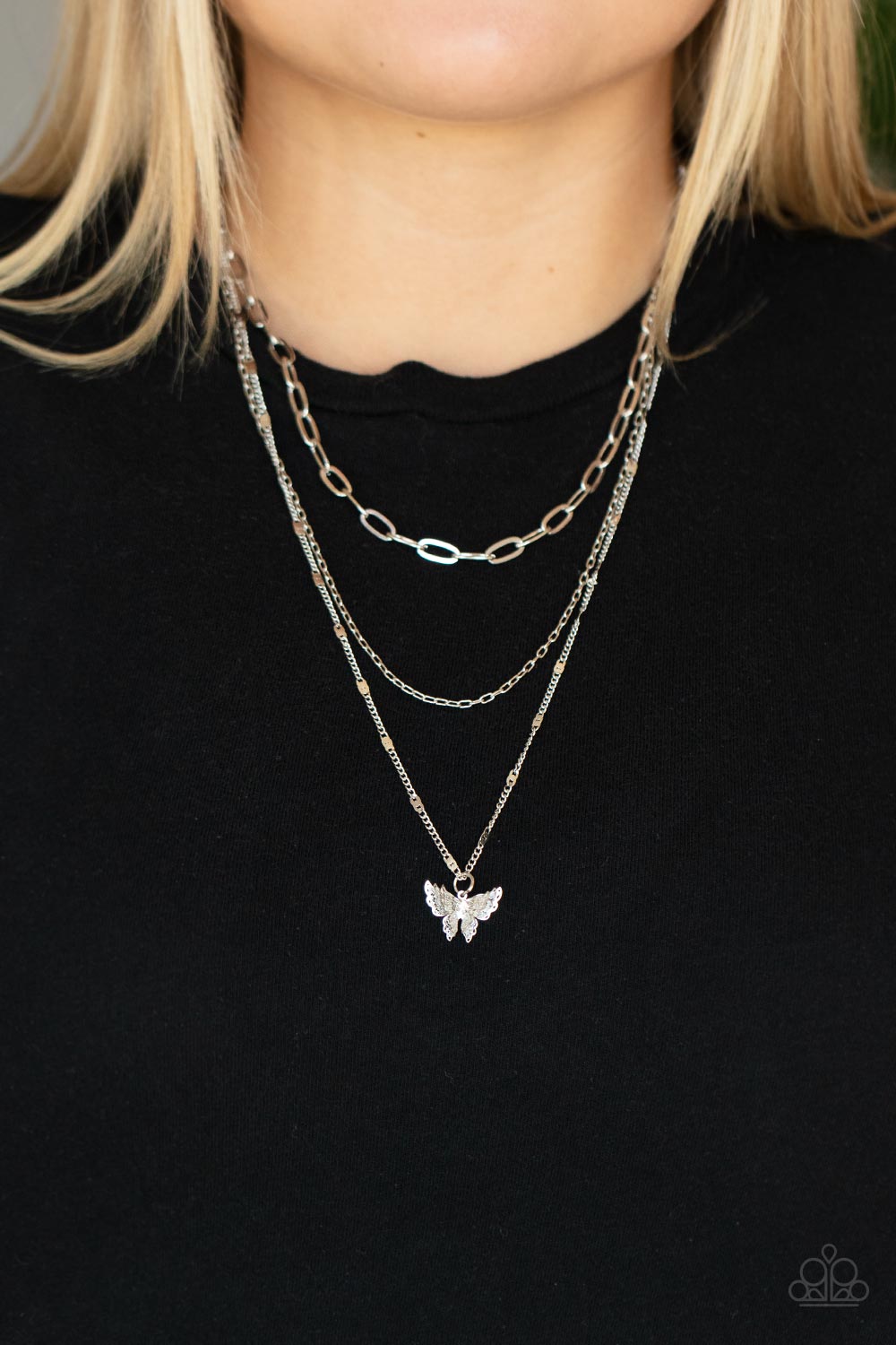 Bountiful Butterflies - Silver Butterfly Fashion Necklace - Paparazzi Accessories - Dotted with a dainty white rhinestone, a decoratively layered silver butterfly swings from the bottom of a display of mismatched silver chains for a whimsically fluttering fashion necklace. 