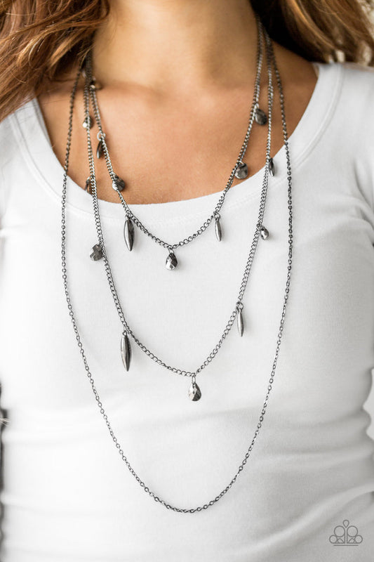 Bravo Bravado - Black Gunmetal Necklace - Paparazzi Accessories - Gunmetal teardrops and shiny gunmetal accents swing from two of the shimmery gunmetal chains for an edgy finish. This necklace has an adjustable clasp closure.
