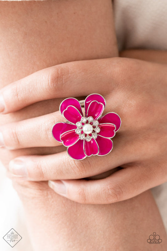 Budding Bliss - Pink Flower Ring - Paparazzi Accessories - An exaggerated pink flower with layers of petals blooms atop the finger in a vibrant display. A white pearl encircled by tiny white rhinestones adds a touch of whimsical sparkle to the design.