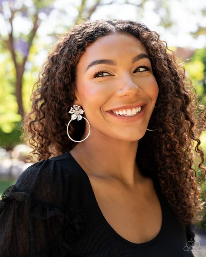 Buttercup Bliss - Silver Floral Fashion Earrings - Paparazzi Accessories - Featuring lifelike textures, a shimmery silver buttercup blooms atop an oversized silver hoop for a whimsical allure. Earring attaches to a standard post fitting. Sold as one pair of post earrings.