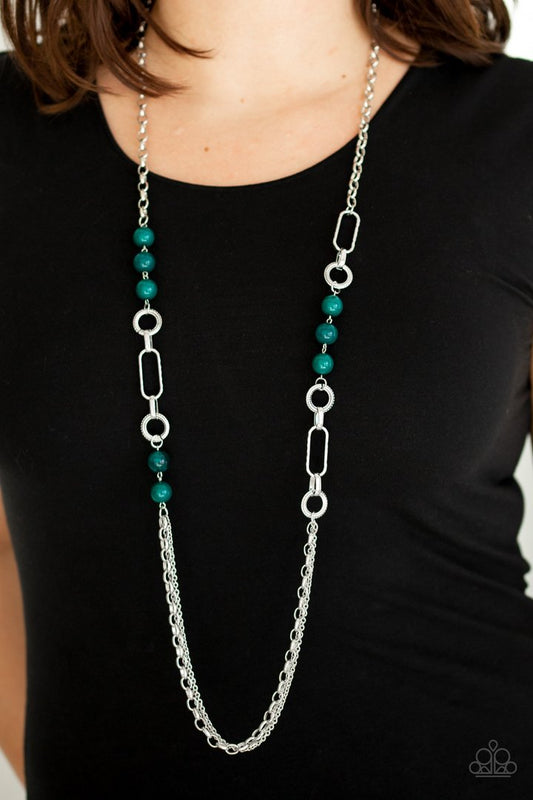 CACHE Me Out - Green and Silver Necklace - Paparazzi Accessories - A collection of glassy and polished green beads give way to layers of mismatched silver chain for a whimsical stylish necklace. Features an adjustable clasp closure.
