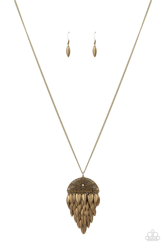 Canopy Cruise - Brass Necklace - Paparazzi Accessories - A canopy of leafy brass frames cascades from the bottom of an ornate filigree half moon frame, creating a noisy pendant at the bottom of a lengthened brass chain. A dainty white rhinestone adorns the center of the frame, adding a hint of whimsy shimmer. Features an adjustable clasp closure. Sold as one individual necklace.