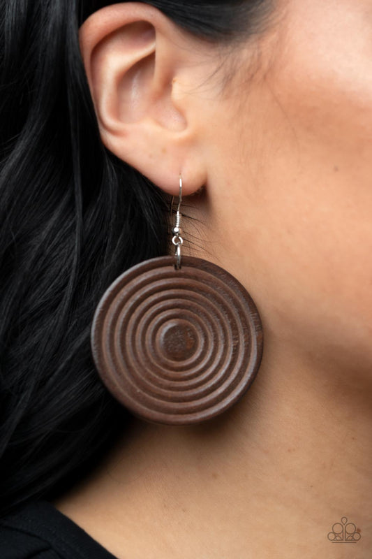 Caribbean Cymbal - Brown Wood Earrings - Paparazzi Accessories - A shiny brown wooden disc is engraved in circular details, resulting in a dizzying pop of color. Earring attaches to a standard fishhook earring. Sold as one pair of earrings.