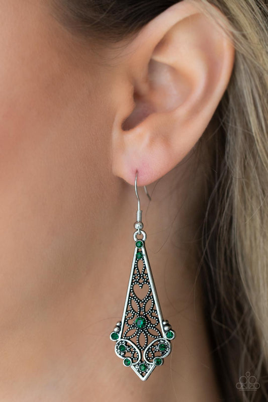 Casablanca Charisma - Green and Silver - Heart and Flower Earrings - Paparazzi Accessories - Heart and flower filigree motifs permeate an elongated diamond-shaped silver frame. Dainty green rhinestones scatter across the design creating a whimsical lure. Earring attaches to a standard fishhook fitting. Sold as one pair of earrings.