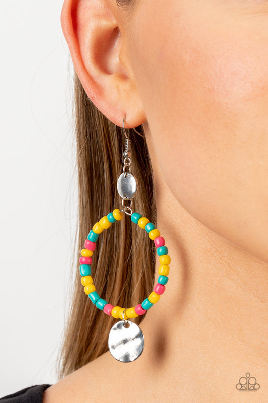 Cayman Catch - Yellow Multi Colorful Earrings - Paparazzi Accessories - Featuring the summery hues of Empire Yellow, Beetroot Purple, and Harbor Blue, dainty seed beads are threaded along a wire hoop that swings between two hammered silver discs for a tropical inspired fashion. Earring attaches to a standard fishhook fitting. Sold as one pair of earrings.