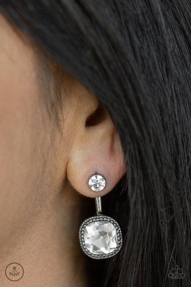 Celebrity Cache - Black / Gunmetal Earrings - Paparazzi Accessories - A solitaire white rhinestone attaches to a double-sided post, designed to fasten behind the ear. Featuring a faceted white gem, the glitzy double-sided post peeks out beneath the ear for a refined look. Earring attaches to a standard post fitting.