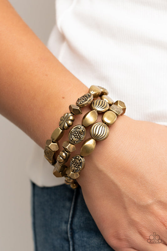 Charmingly Cottagecore - Brass Floral - Coil Bracelet - Paparazzi Accessories - An enchanting assortment of rustic, faceted, and floral brass embossed beads alternates along a coiled wire, creating a whimsical infinity style bracelet around the wrist.