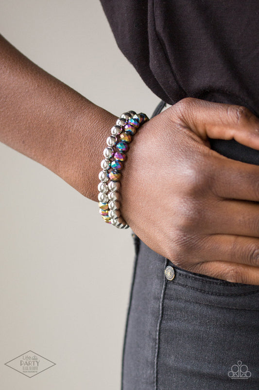 Chroma Color - Multi Color - Rainbow Iridescent Bracelet - Paparazzi Accessories - Dipped in a rainbow iridescence, a collection of metallic crystal-like beads and shiny silver beads are threaded along two stretchy bands around the wrist for a stellar look. Sold as one set of two bracelets.