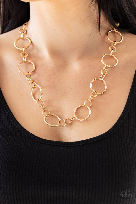 Classic Combo - Gold Fashion Necklace - Paparazzi Accessories - Oversized gold hoops link with dainty twisted gold rings below the collar for a classic combination. Features an adjustable clasp closure. Sold as one individual necklace.