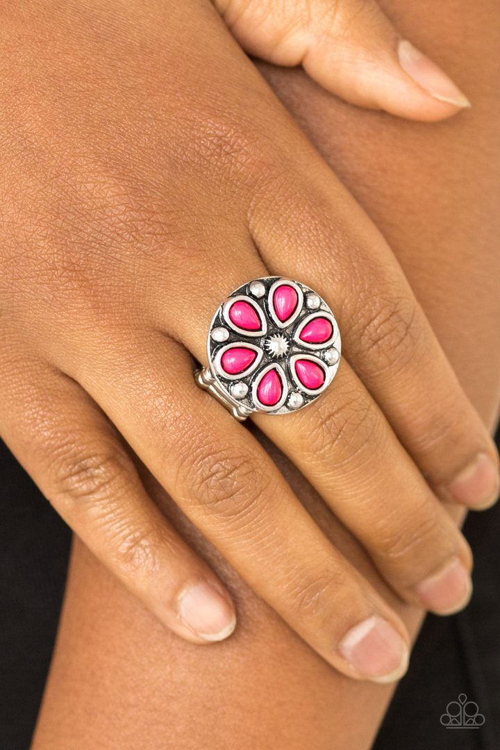Color Me Calla Lily - Pink & Silver Ring - Paparazzi Accessories - 
Vivacious pink beads are pressed into a studded silver frame, creating a colorful floral centerpiece atop the finger. Features a stretchy band for a flexible fit.
