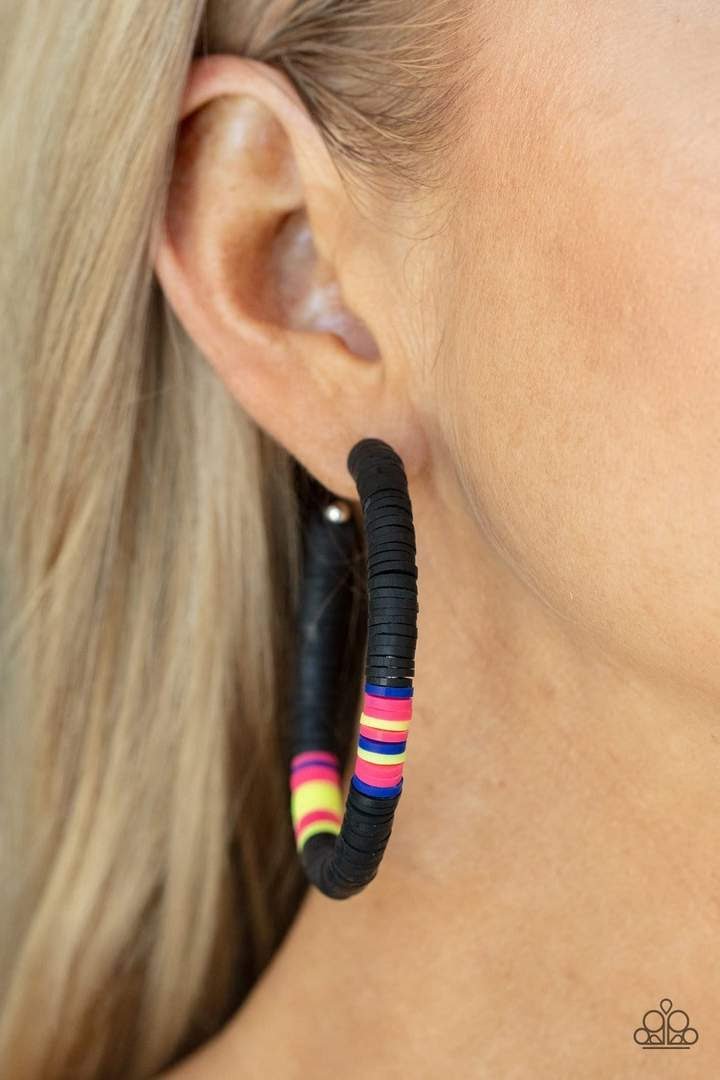 Colorfully Contagious - Black Hoop Earrings - Paparazzi Accessories - Rubbery black, pink, blue, and yellow bands are threaded along an oversized silver hoop, creating a courageous pop of color. Earring attaches to a standard post fitting. Hoop measures approximately 2 1/4" in diameter. Sold as one pair of hoop earrings. -  Bejeweled Accessories By Kristie - Trendy fashion jewelry for everyone -