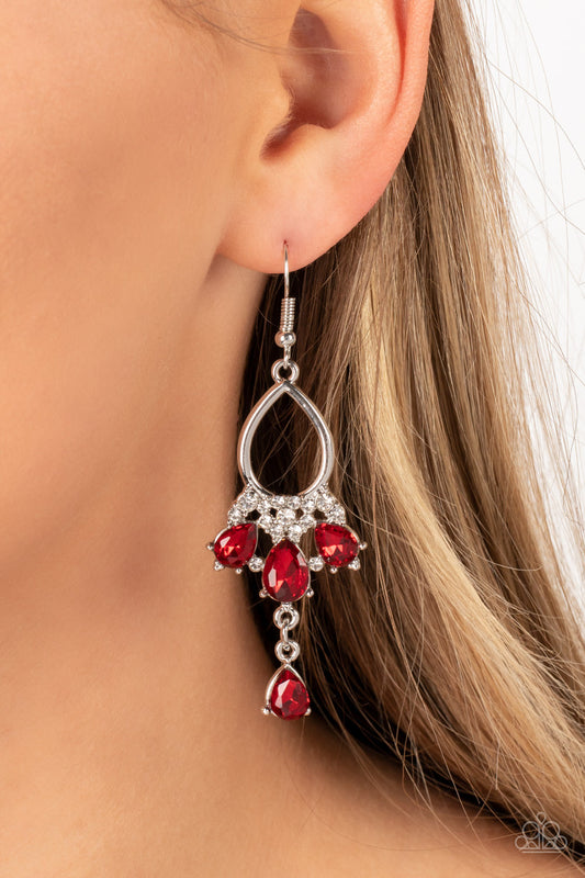 Coming in Clutch - Red and Silver Earrings - Paparazzi Accessories - A solitaire red teardrop rhinestone sways from the bottom of a fan of red rhinestone teardrops that flares out from a white rhinestone floral accent at the bottom of an airy silver frame, resulting in a modern chandelier. Earring attaches to a standard fishhook fitting. Sold as one pair of earrings.